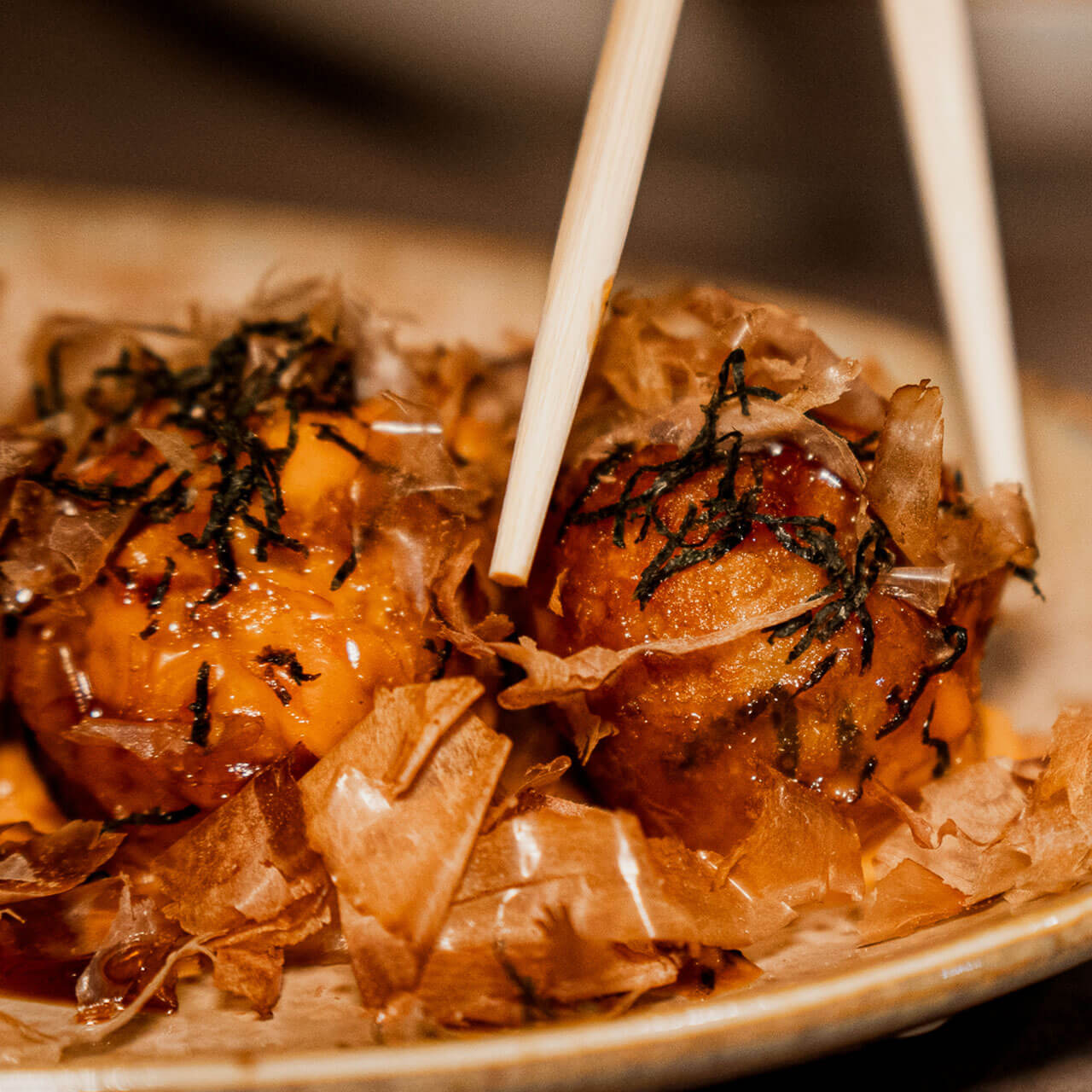 Japanese ball-shaped snack made with cabbage and octopus, widely recognized as a quintessential example of Osaka street food.